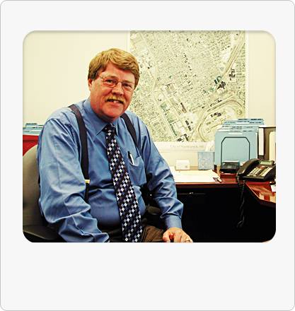 Former City Manager William Cooper and the city have reached a lawsuit agreement over his abrupt firing in March 2012.