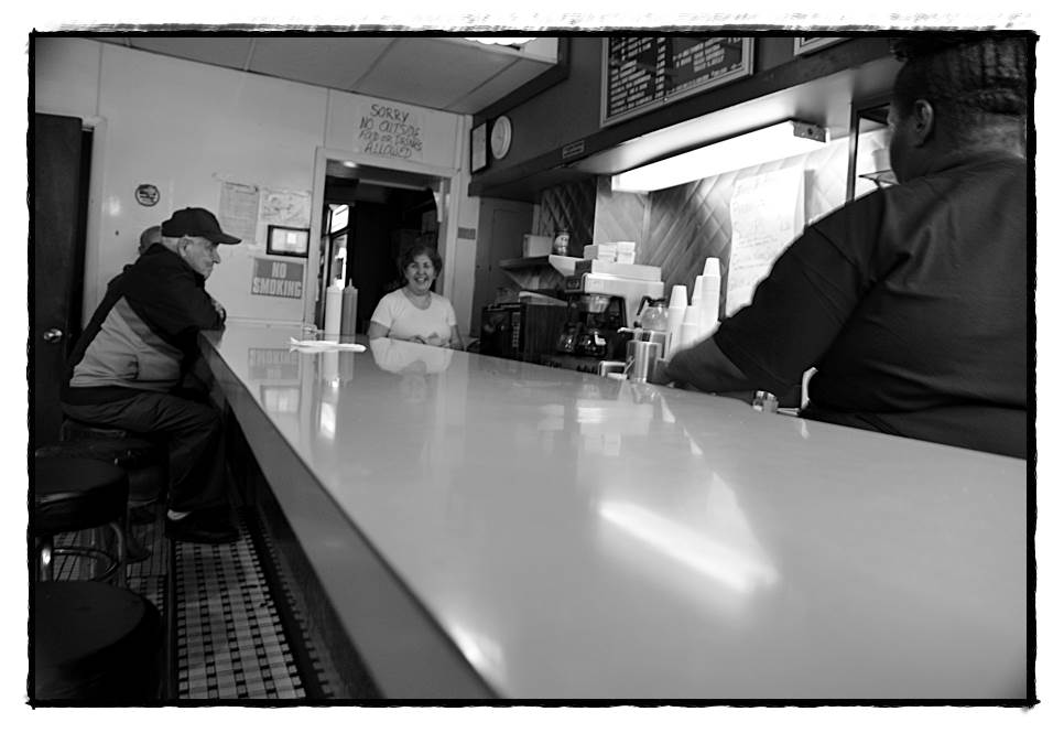 Sandy Bakic (center) said that after 30 years operating the Campau Tower, it’s time to close for good. The landmark hamburger joint served up its last meal on Sunday at 10 p.m.