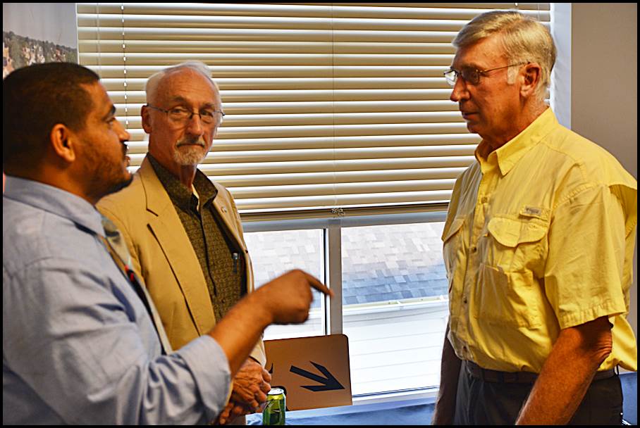 City Treasurer John Gabor (right) talks with City Councilmember Saad Almasmari (left) after he was appointed as acting city manager.