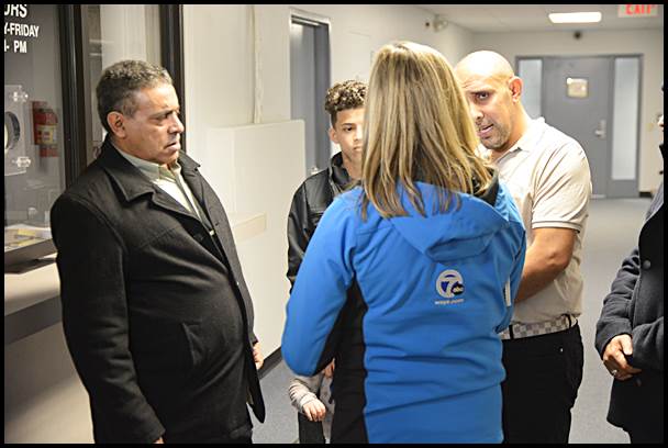 Nasser Almasmari (left) speaks through an interpreter about his experience with a Hamtramck police officer during a traffic stop. He was being interviewed by a reporter for WXYZ-TV Channel 7.