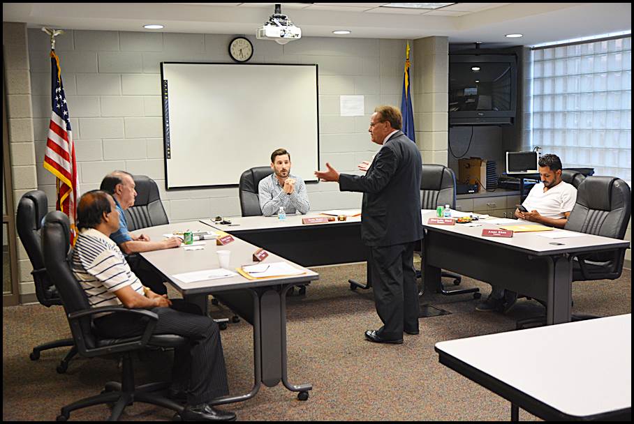 Hamtramck Public Schools Superintendent Tom Niczay talks to the School Board before Wednesday’s monthly meeting. Niczay announced his plan to retire by the end of the upcoming school year at the meeting.